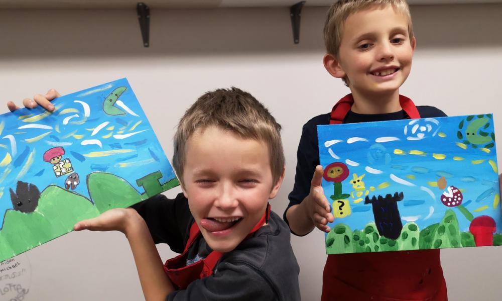 Two students showing off their Super Mario Painting